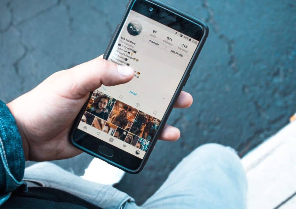 Someone holding a phone displaying instagram