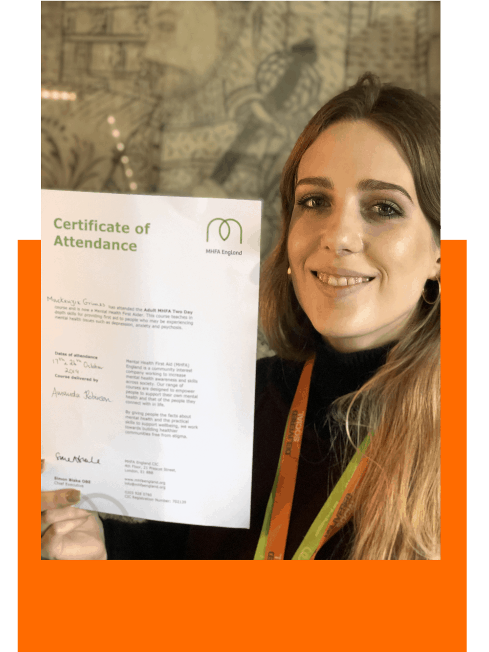 Mackenzie holding her MHFA certificate