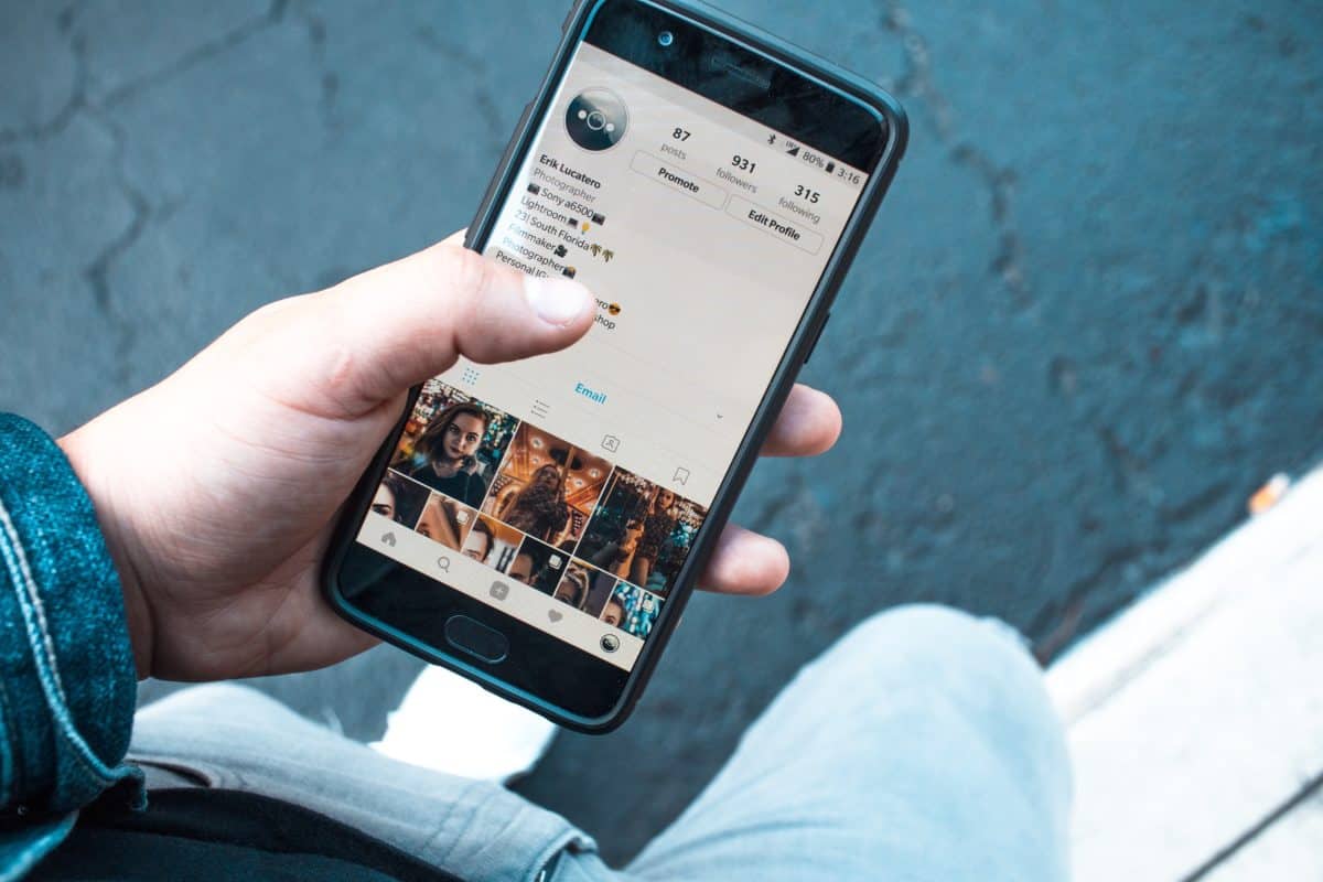 find influencers on Instagram: person holding smartphone with Instagram displaying