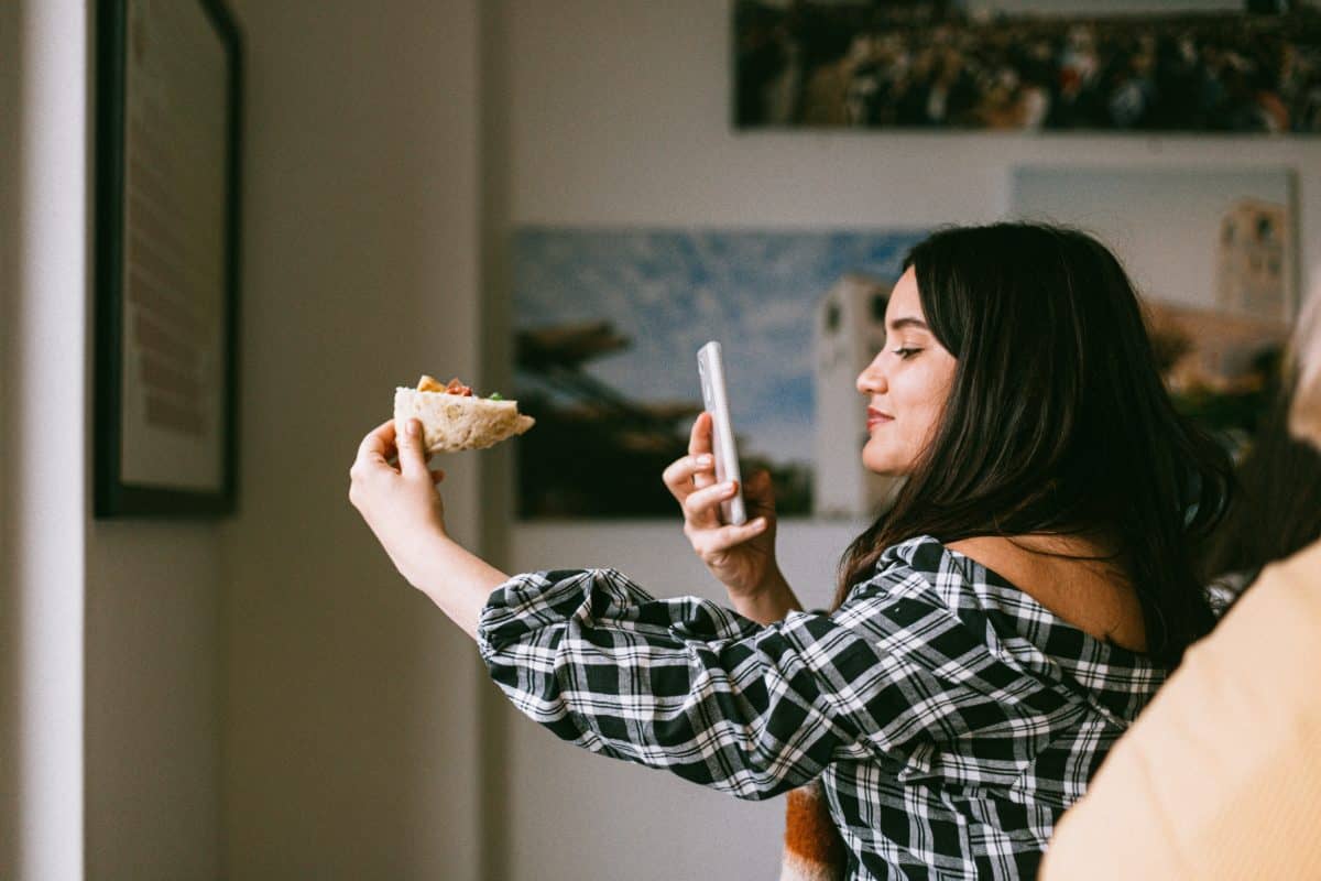 Find instagram influencers uk: woman taking photo of food