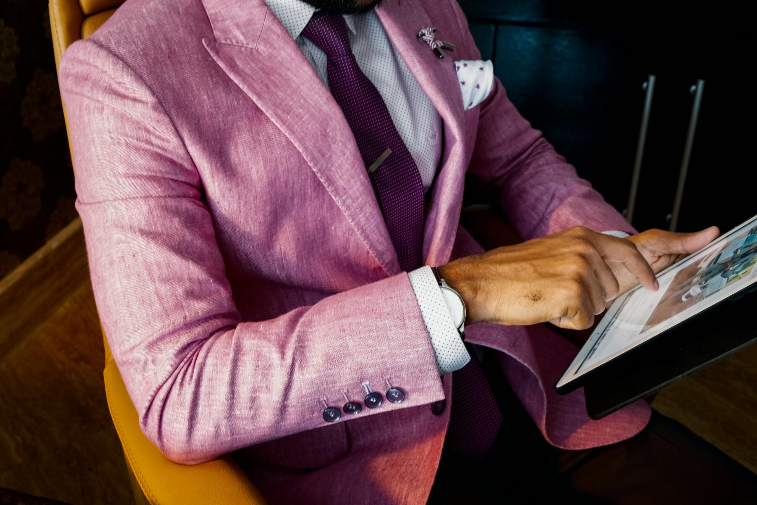 Man In Pink Suit Browsing Website on ipad - Ecommerce Website Design Dubai