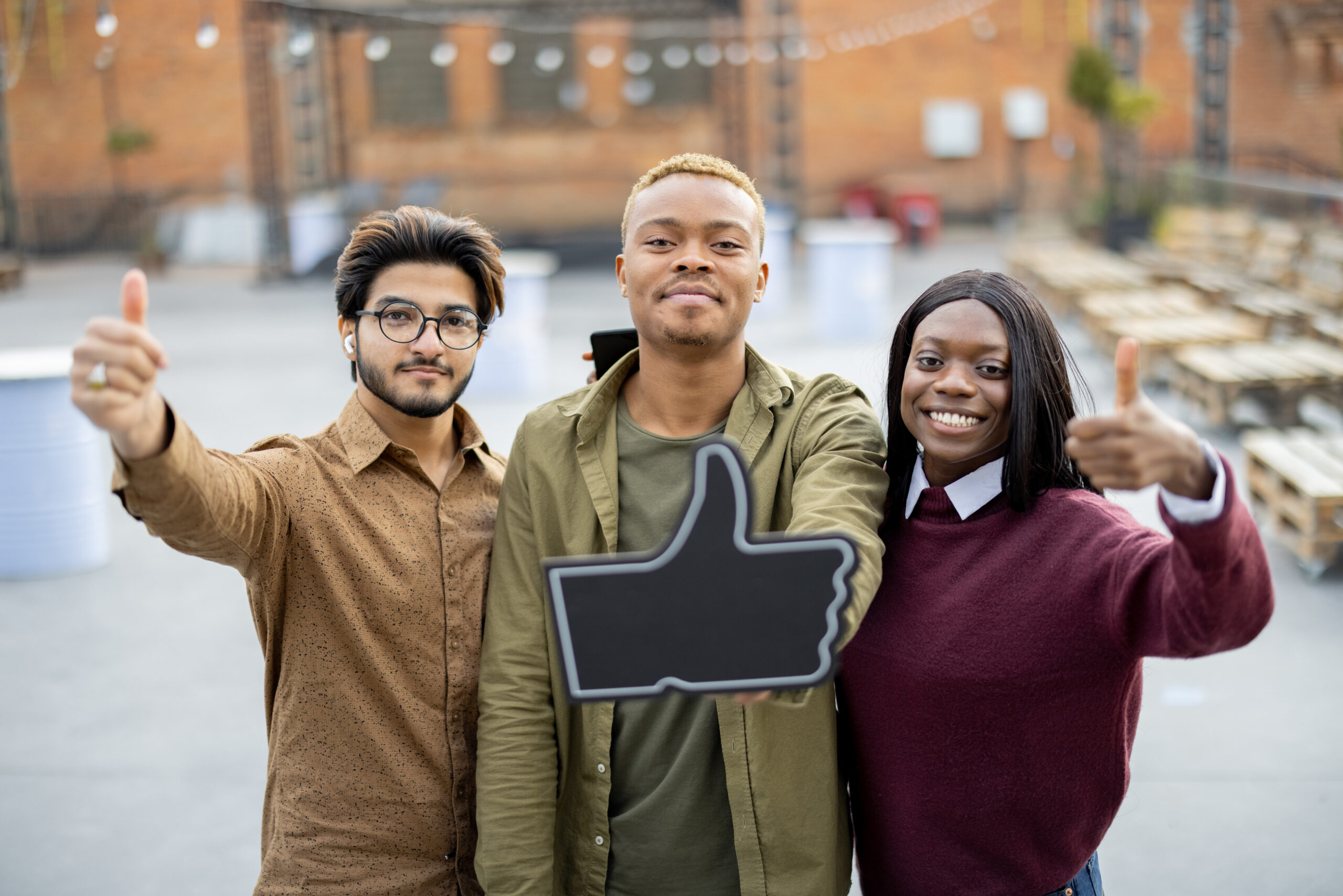 Grow Comments and Shares Quickly Across Social Media Platforms - guy holding phone and like sign