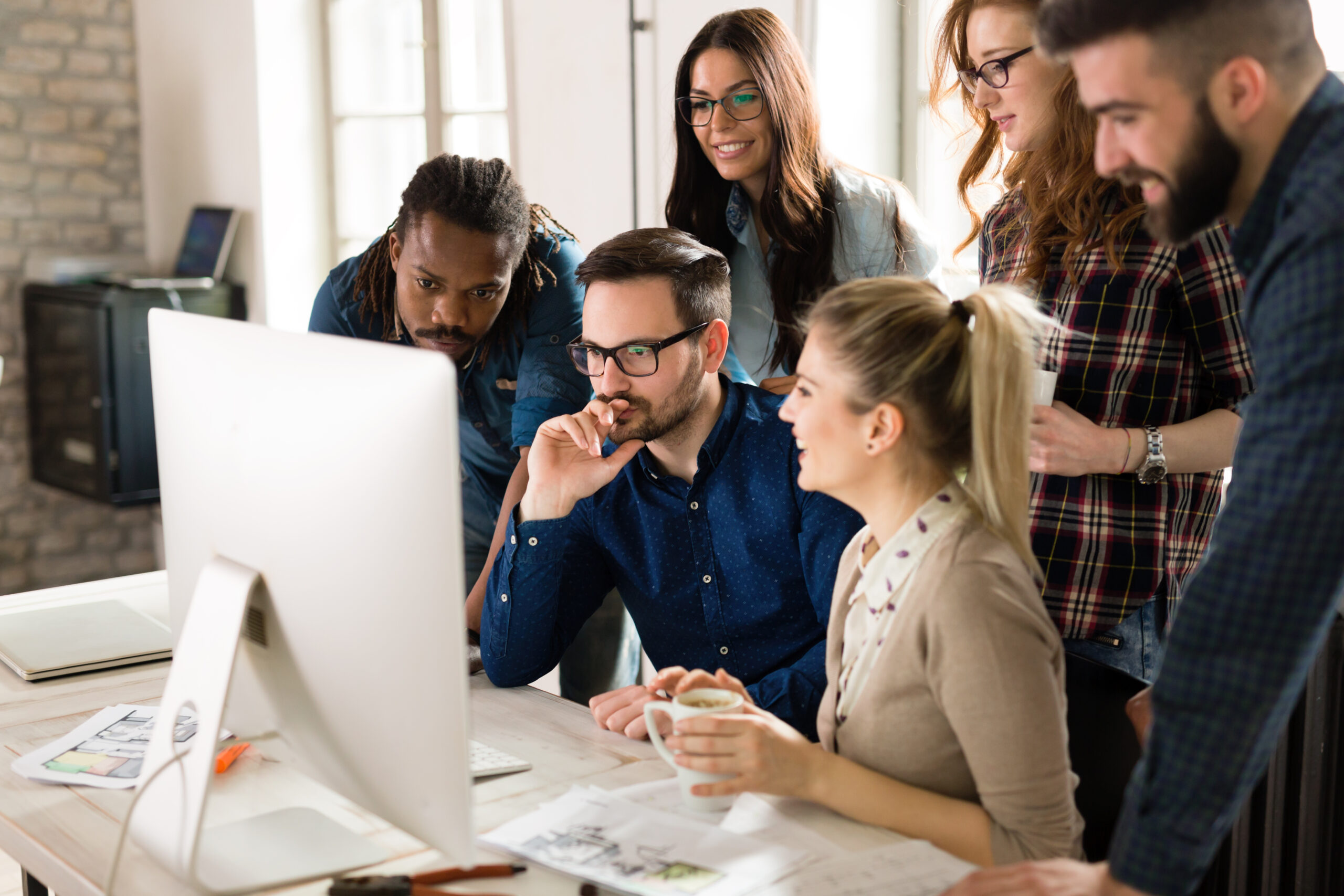 Leading-Local-Web-Design-Firms-to-Grow-Your-Online-Presence-Now-designers-working-together-scaled.jpg