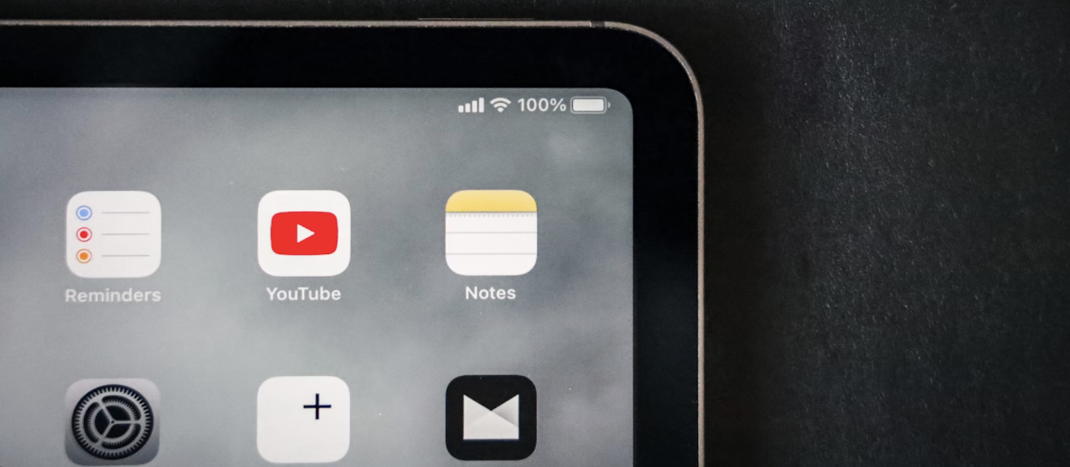 Close-up of iPad screen showing YouTube, Reminders, and Notes app icons.