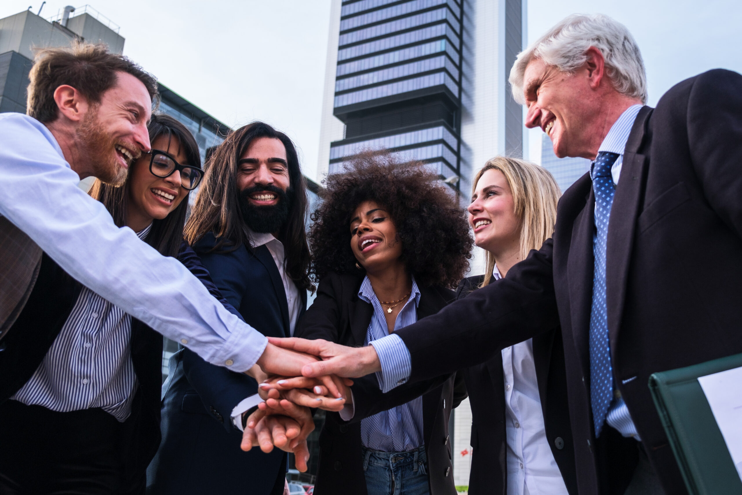 Creative Local Business Engagement Ideas to Strengthen Community Ties - business community putting hands together