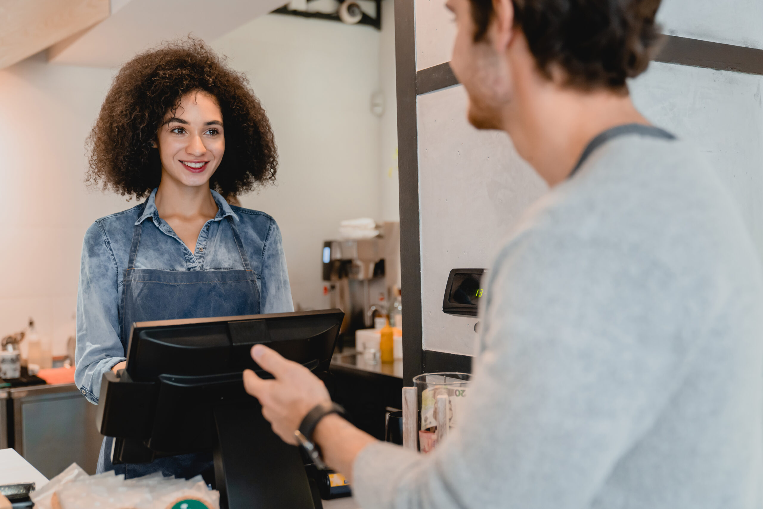 Creative Referral and Reward Ideas to Boost Customer Loyalty - waitress serving customer with loyalty card