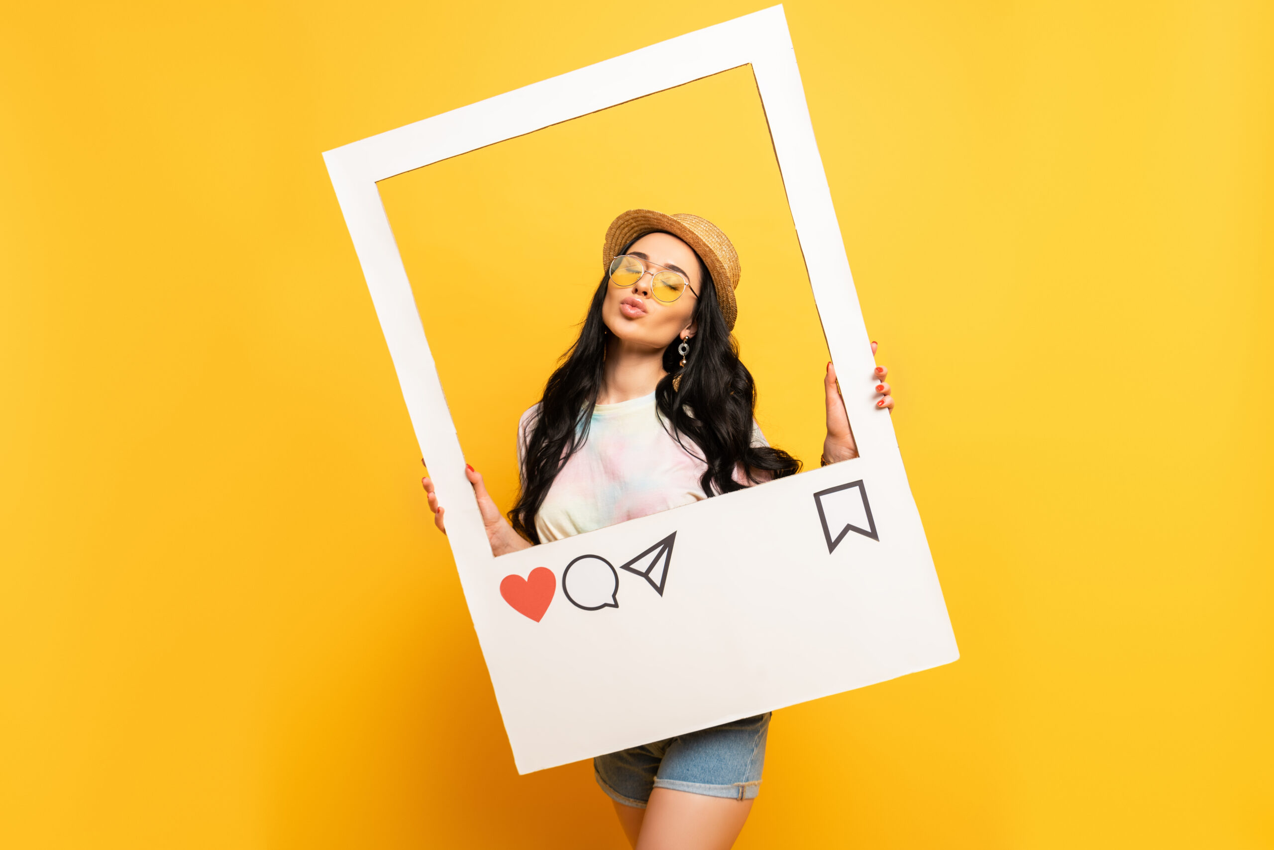 Engagement Strategy for Instagram Growth For Reach and Visibility - girl smiling holding instagram frame for photo