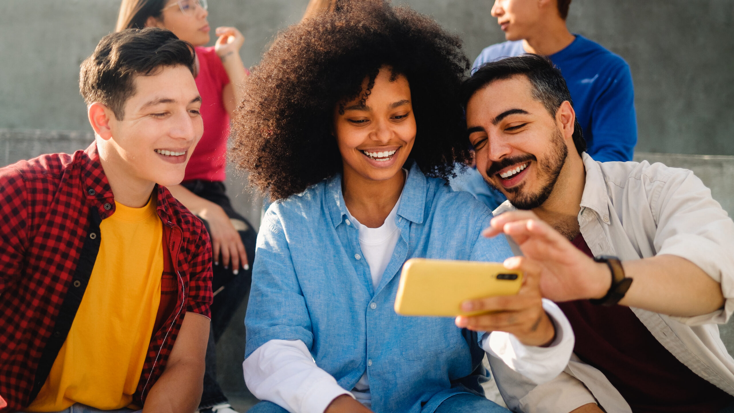 Social Media Support for Startups - Professional Designers Working Together - Young People on Their Smartphones