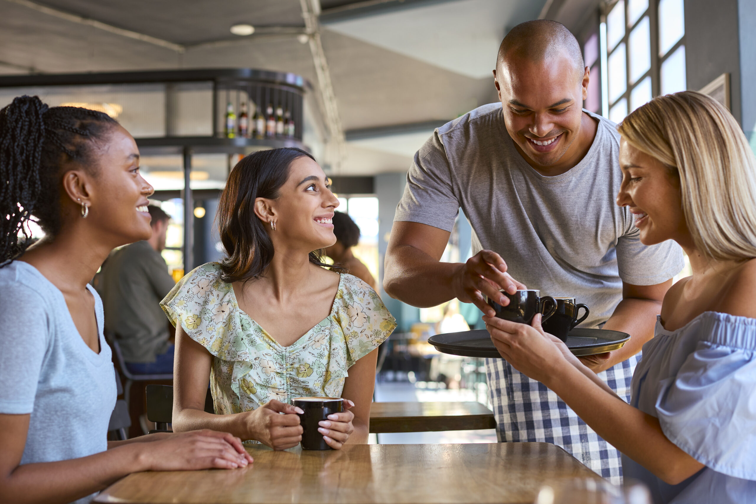 Unique Customer Engagement Ideas That Will Inspire Loyalty and Repeat Business - group of friends smiling in a restaurant