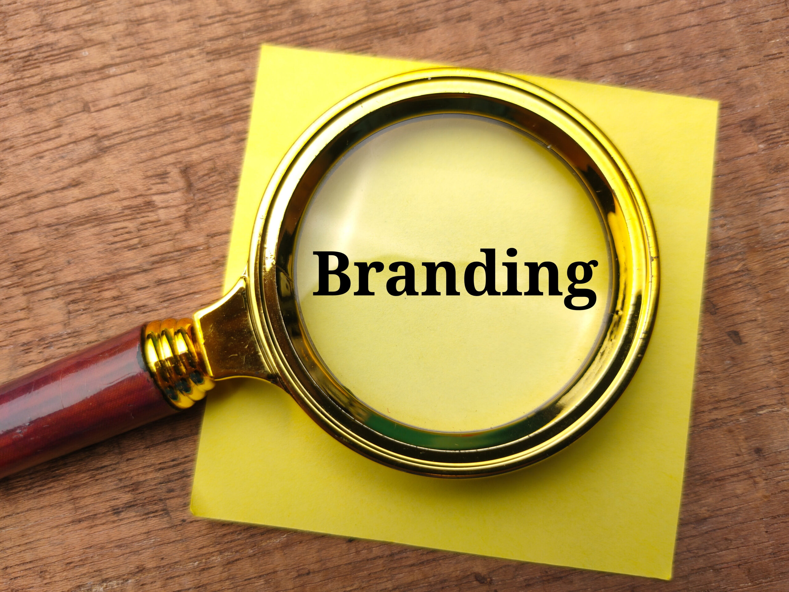 Define Your Brand Identity - Strategies for Achieving Business Success - Magnifying Glass over Brand