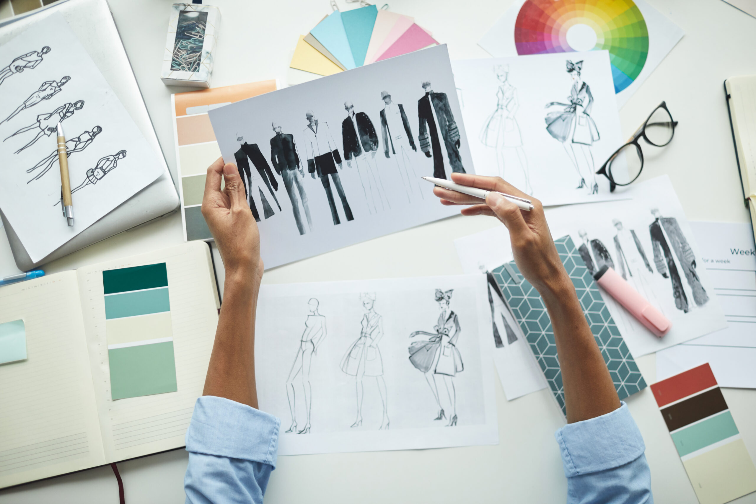 Effective Brand Identity Design - Strengthen Your Business Impact - designer examining sketches