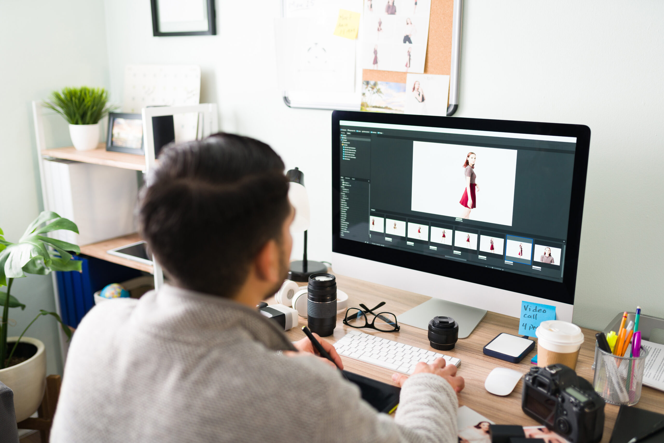 How Outsource Content Creation Can Benefit Your SME - man at desk editing photos