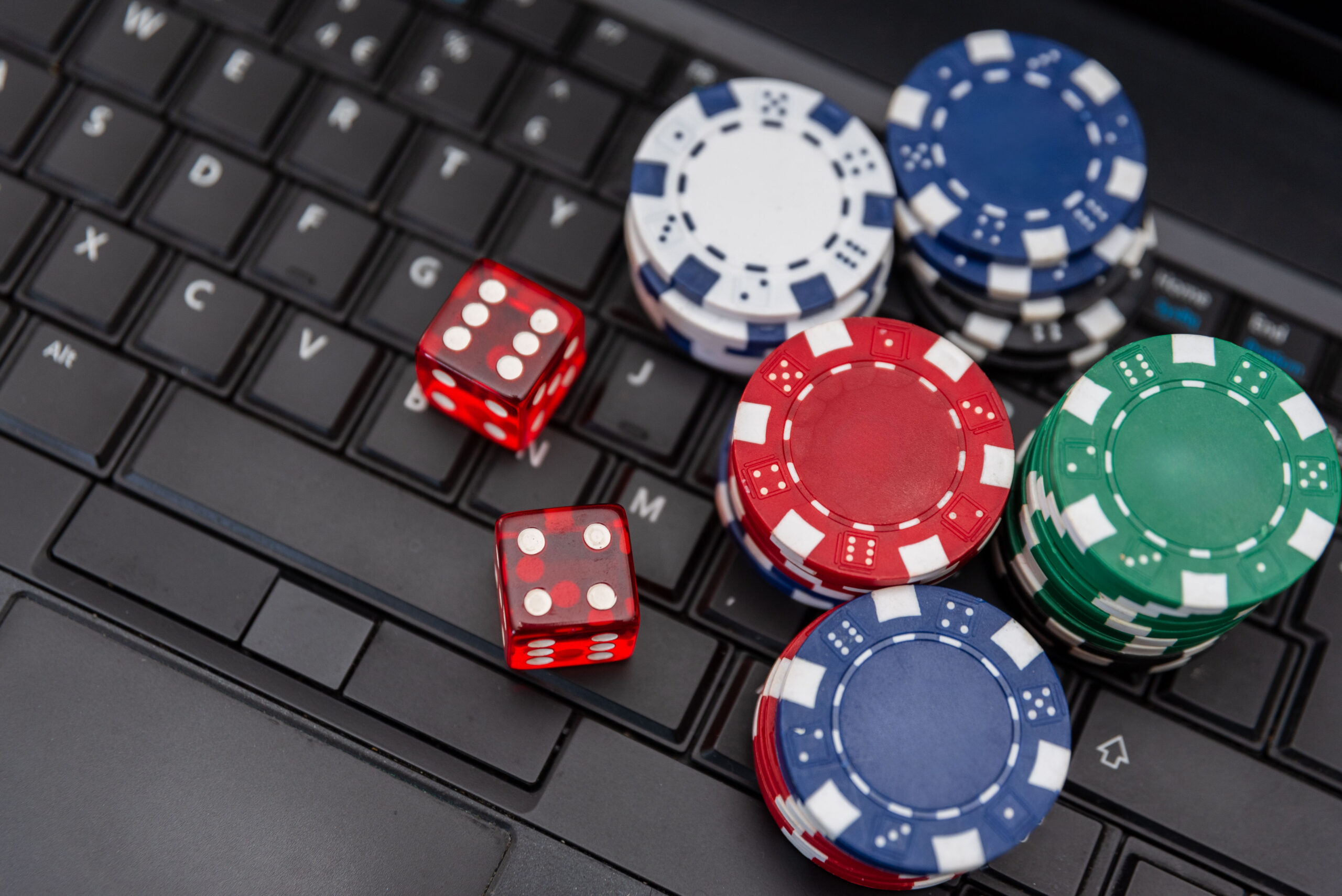 Proven Tactics in Email Marketing for Casino Retention - poker chips and dice on laptop