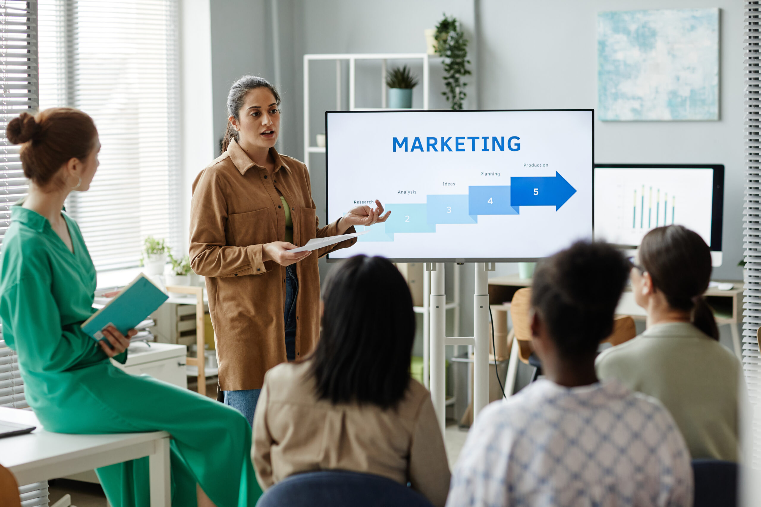 The Importance of B2B Marketing in Driving Business Growth - women presenting marketing plan