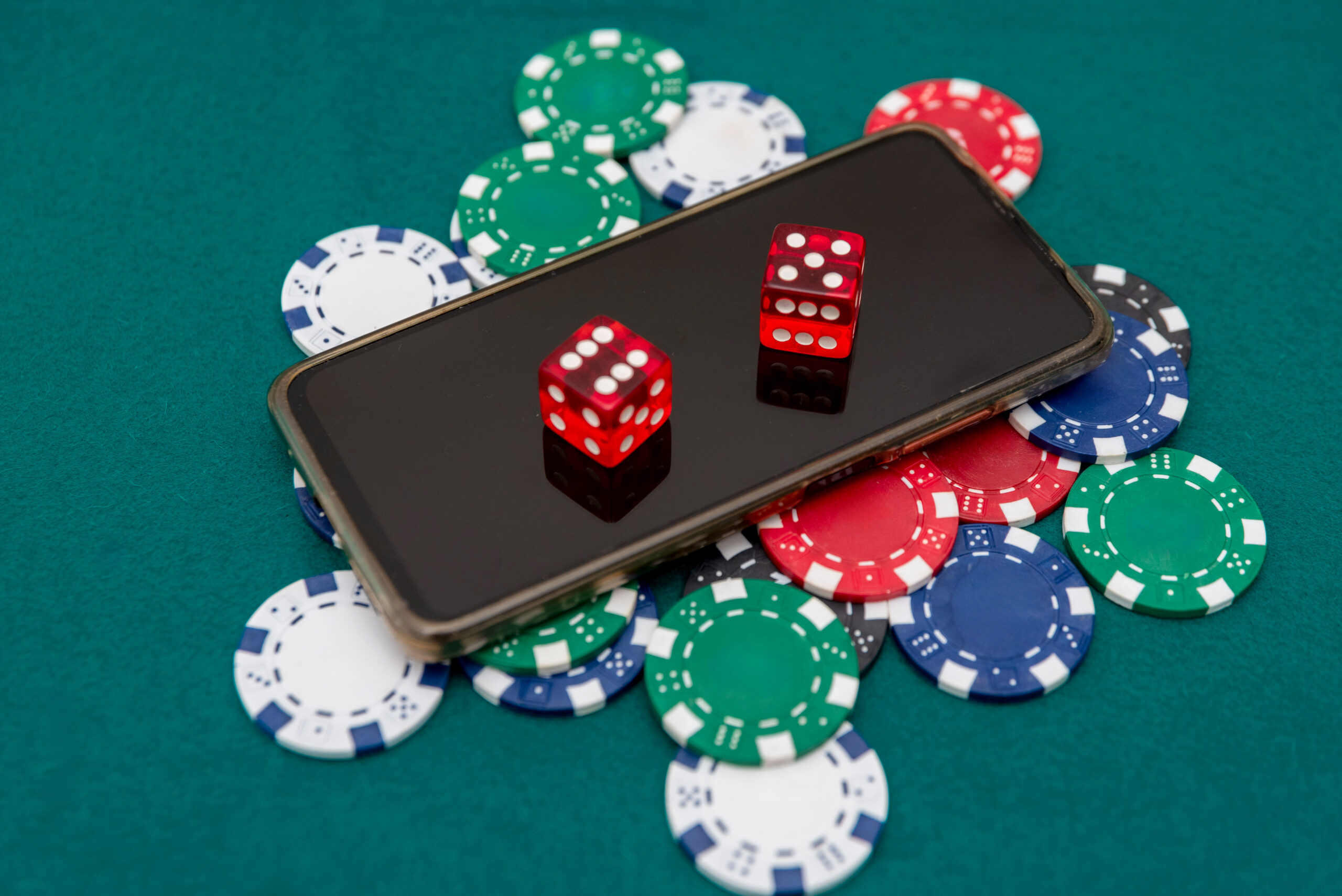Winning Tactics with Social Media for Casino Marketing - red dice on iphone with casino chips.