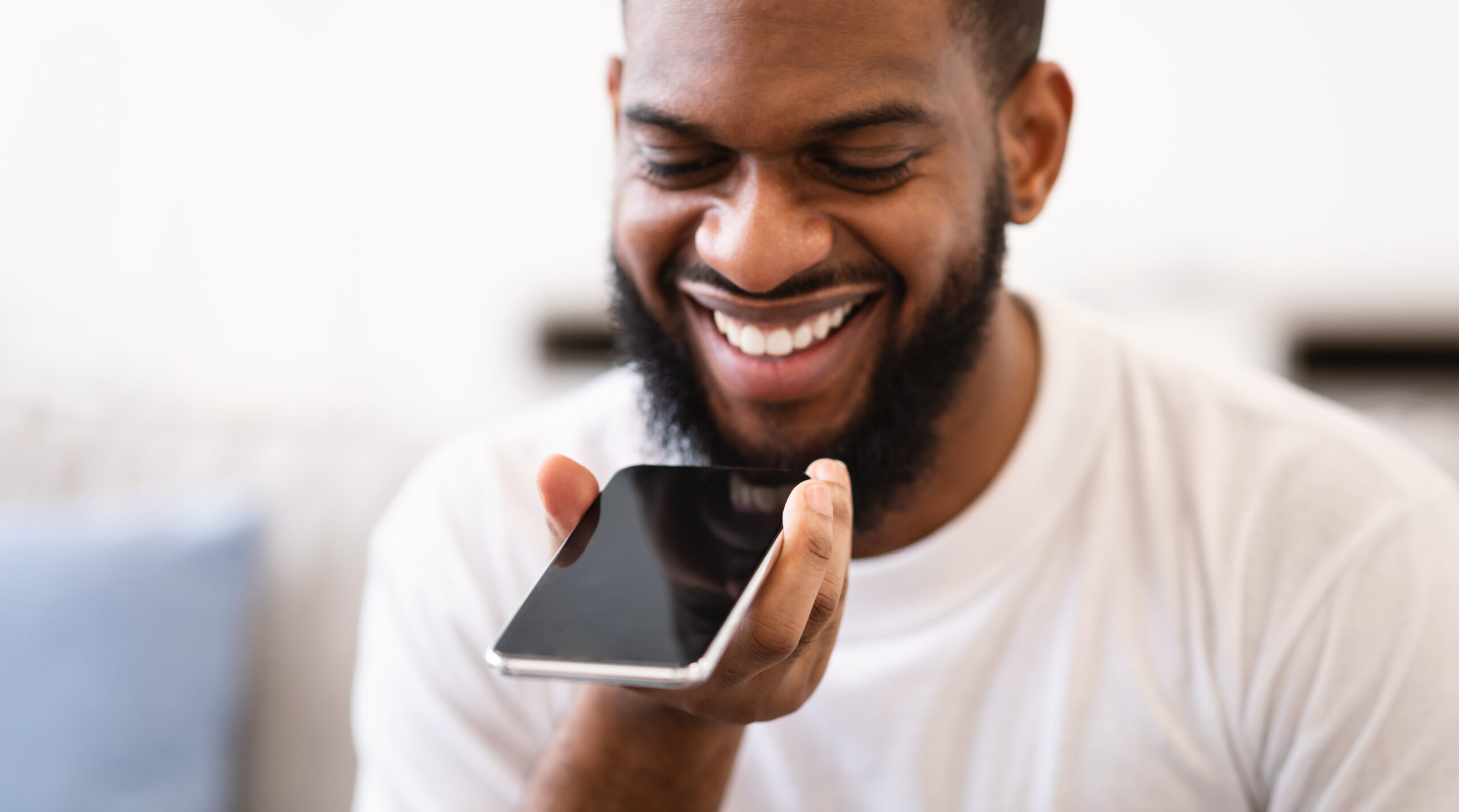 A person laughing because their friend showed them a few funny easter eggs on Google