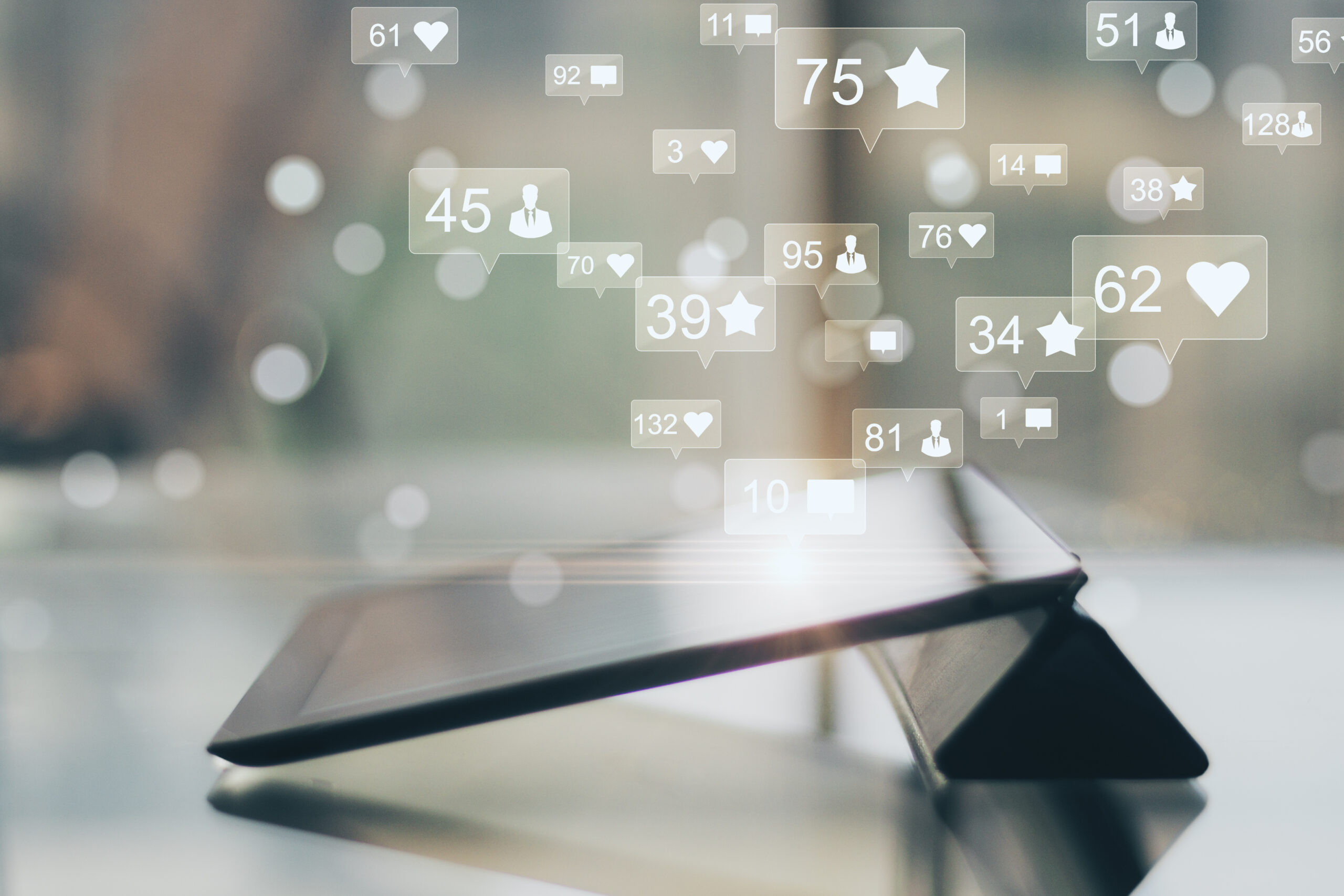 Side view and close up of tablet emitting increased social media engagement as a result of social media optimisation