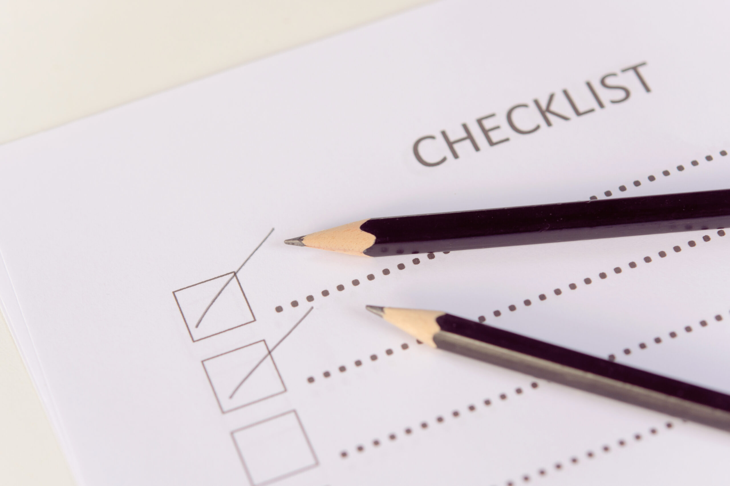 Two pencils on a checklist, showing how important it is to test website seo online