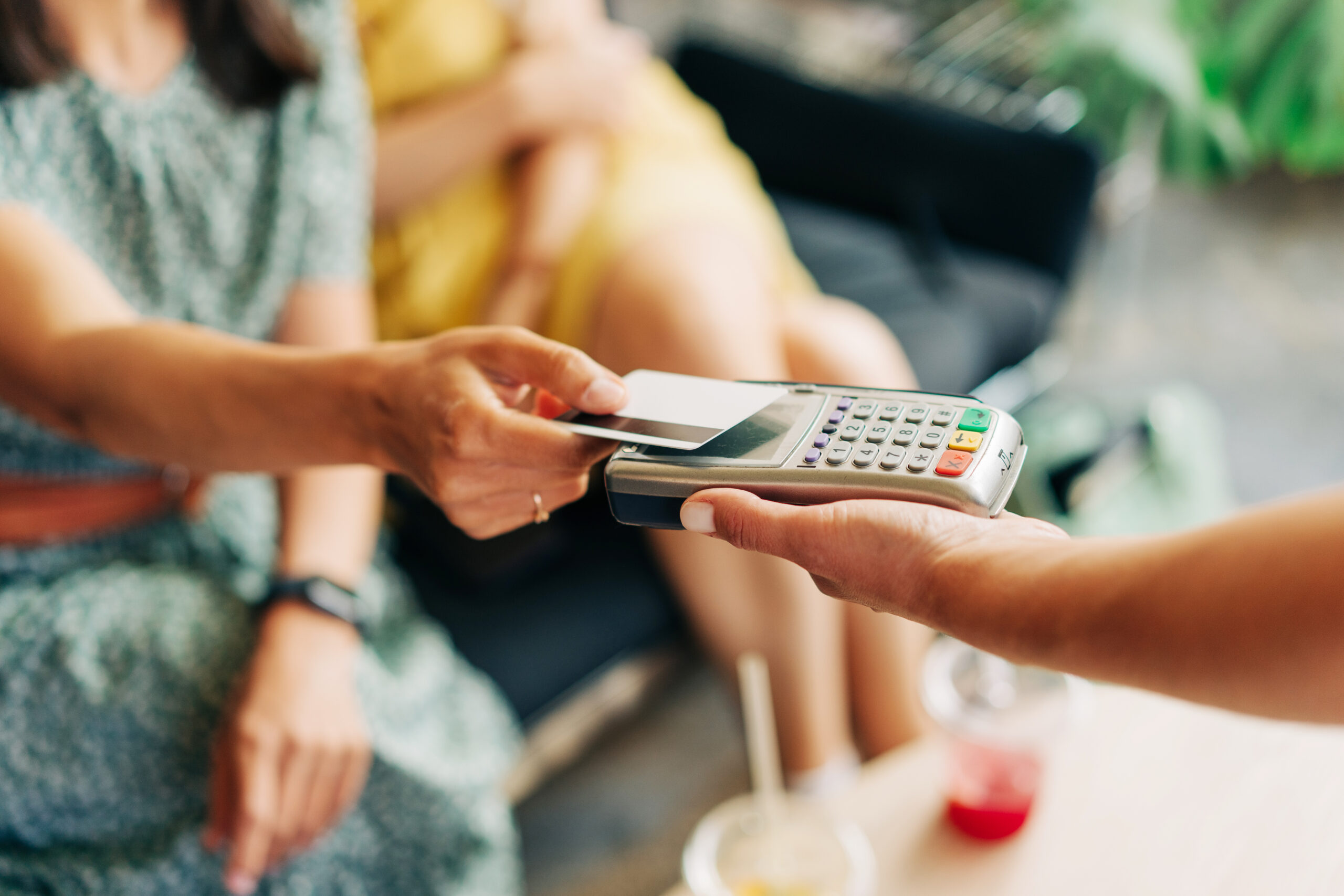 A client paying with their card for the website design cost