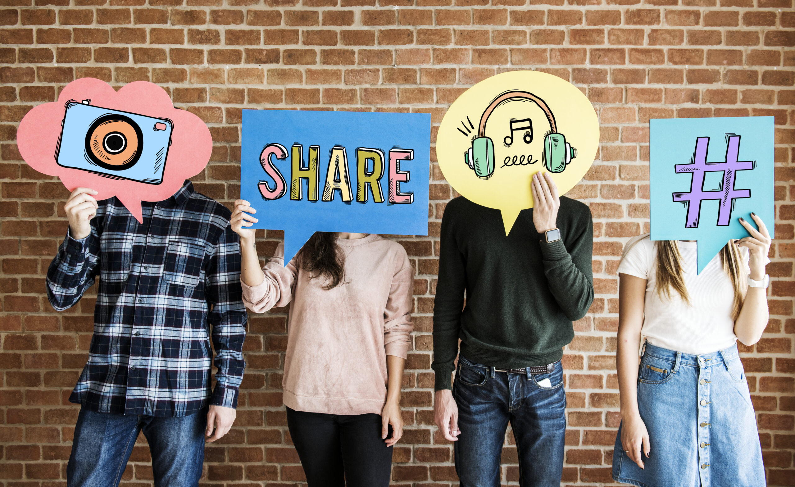 A group of people holding signs resembling social media interactions and social media metrics