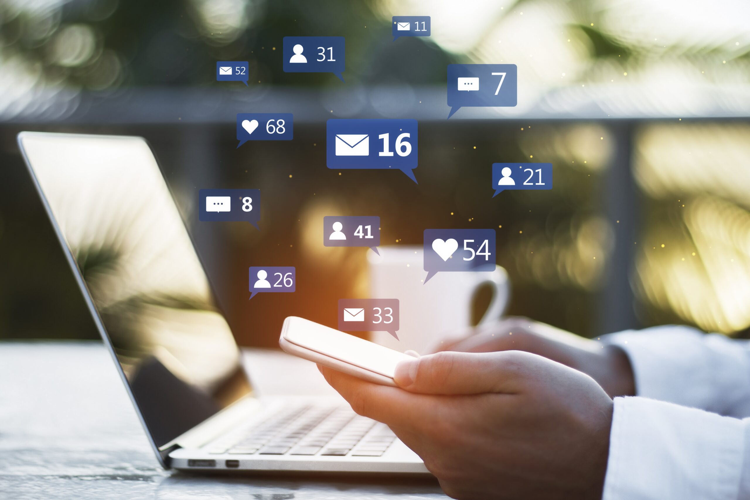 Outsource Social Media Management - hand swiping social media on phone