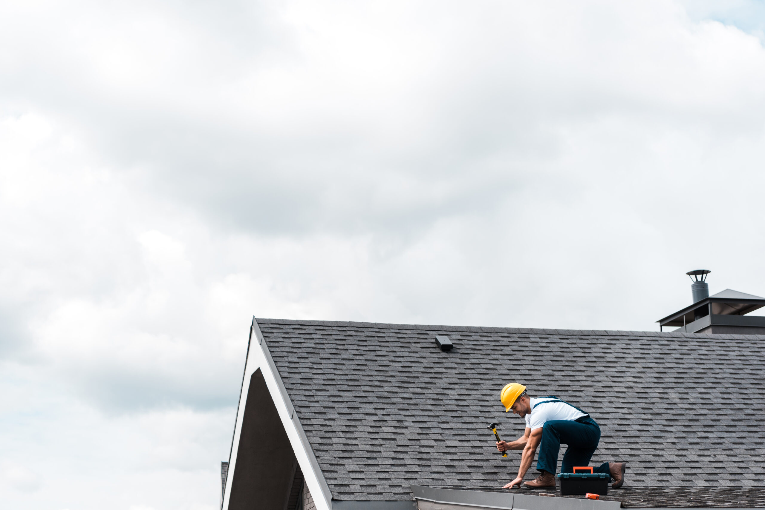Roofing SEO Services - Roofer working on house