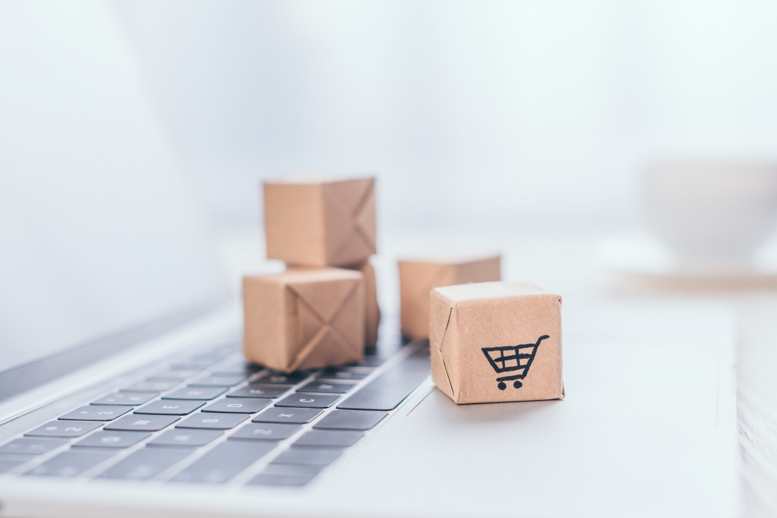 eCommerce Awards UK - packages on top of laptop with trolleys on them