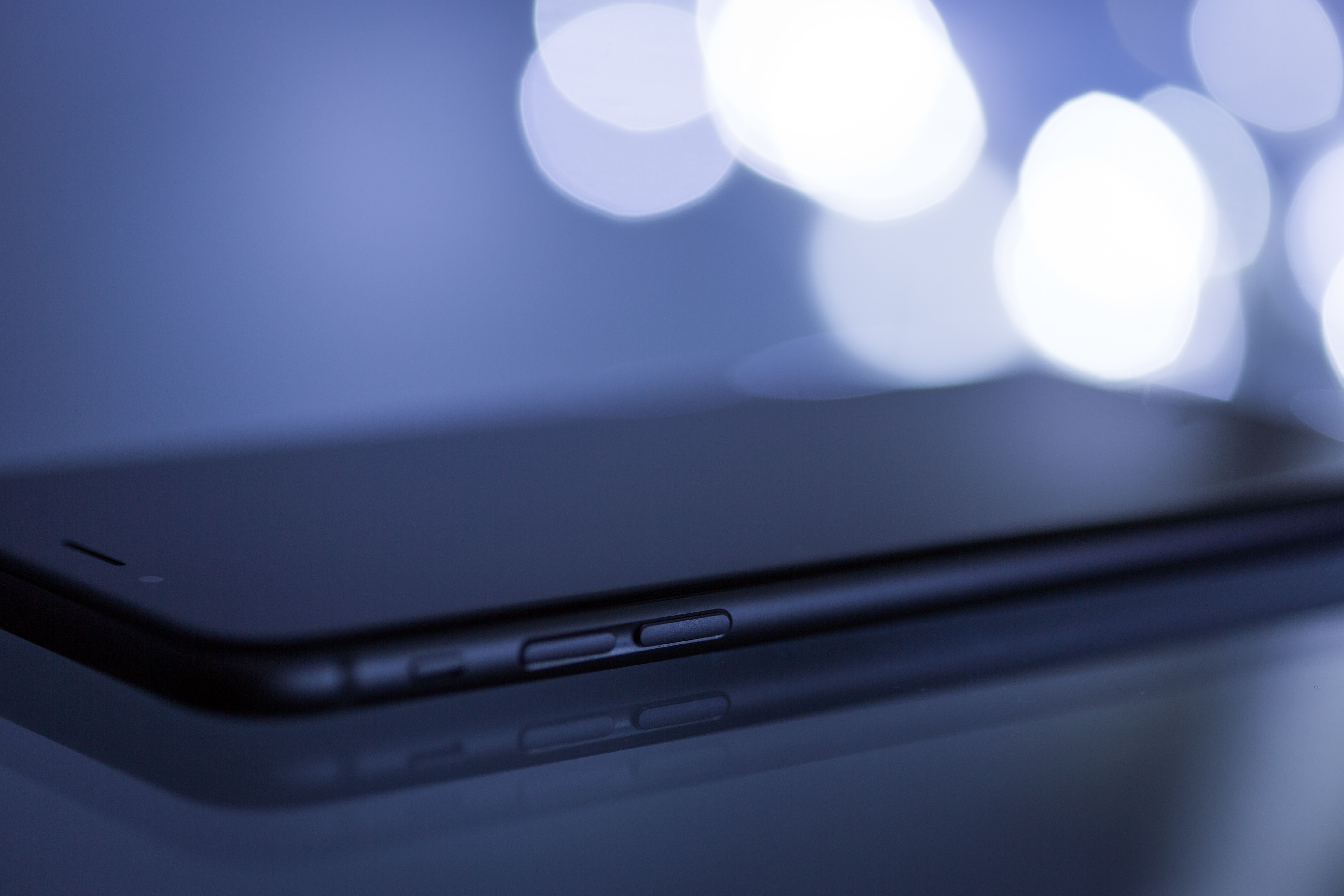 Close-up shot of a sleek smartphone with a blurred bokeh background, emphasizing its modern design.