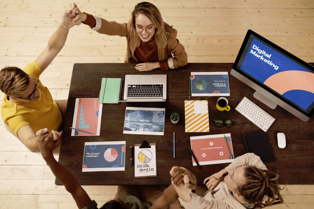 Business founders planning a digital marketing budget around a table