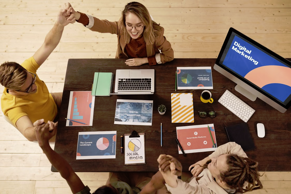 Business founders planning a digital marketing budget around a table